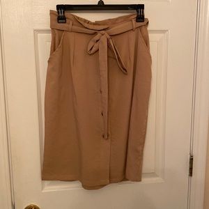 Mid-length brown skirt with front tie and buttons.